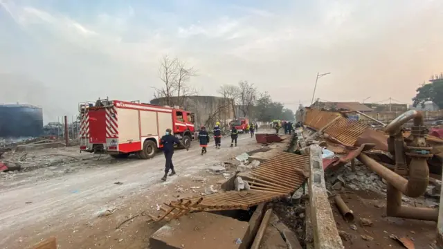 Firemen respond to the scene of fire after a blast at an oil terminal in Conakry, Guinea December 18, 2023.