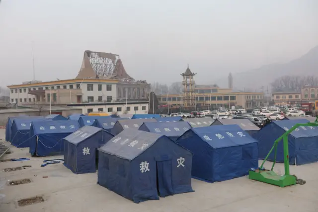A dozen blue tents set up for evacuees in Dahejia an area of Jishishan County