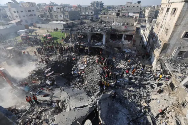 People gather at the site of an air strike in Rafah, Gaza