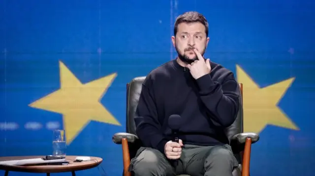 Volodymyr Zelensky listens to a question from a journalist during a press conference in Kyiv