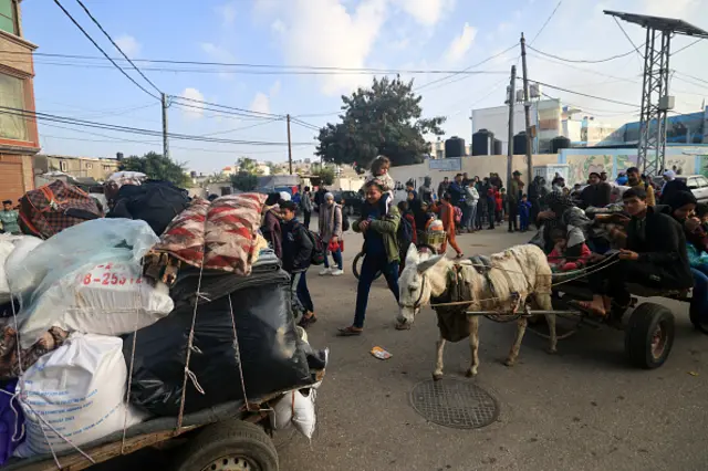 Palestinians ride donkey-pulled carts as they flee toward safer areas following the resumption of Israeli strikes on Khan Younis, 1 December 2023