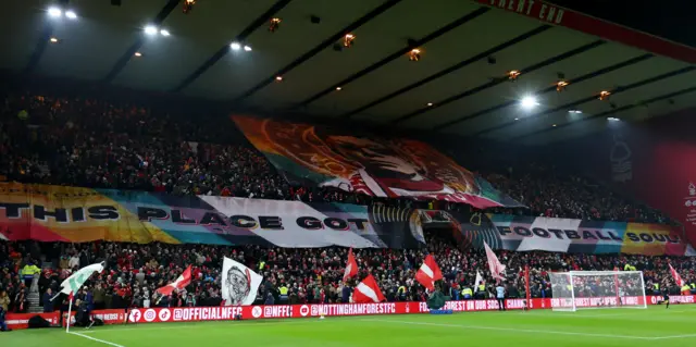 Fans hold up a banner reading: 'This club got a football soul'