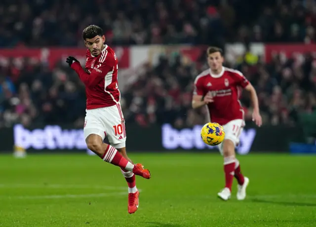 Gibbs-White flicks the ball into the box on the volley.