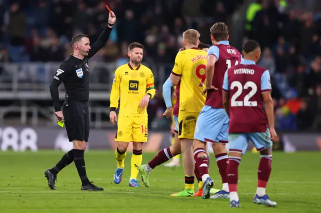 McbUrnie is shown a second yellow and then red card.