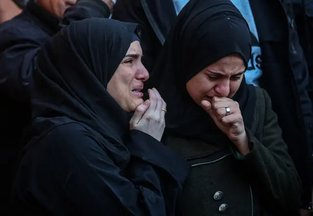 Palestinians mourn as they collect the bodies of their loved ones killed in an airstrike on 2 December 2023 in Khan Yunis, Gaza