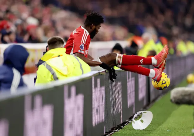 Sangare sits on top of the advertising boards moments after falling over them.