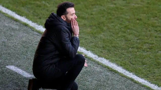 West Brom manager Carlos Corberan crouches