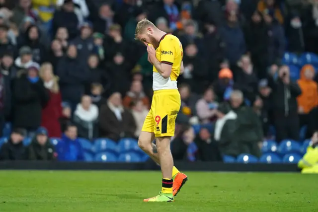 Mcburnie wipes his face after being sent off.