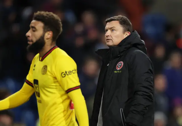 Heckingbottom walks off the pitch with a dejected look on his face.