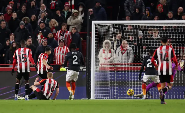 Maupay smashes the ball into the net for the opening goal.