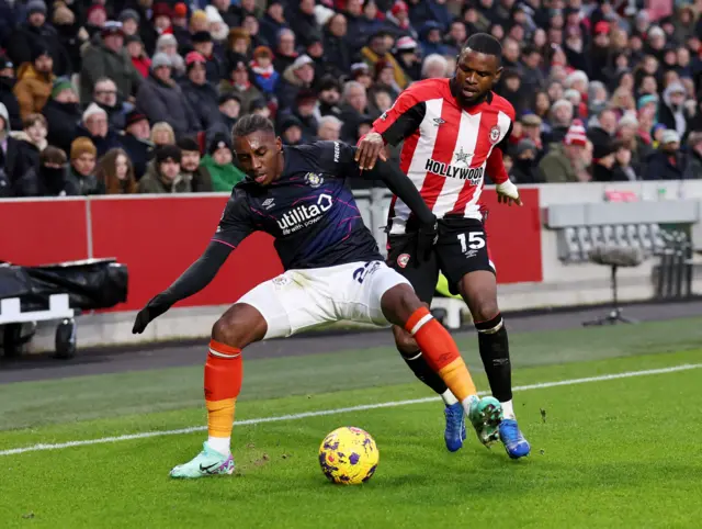 Bell and Onyeka duel for the ball near the touchline.