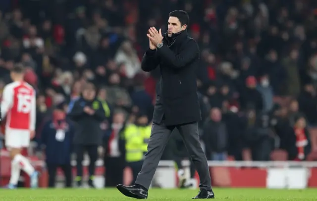 Arteta strolls around the pitch clapping the Arsenal fans at full time.