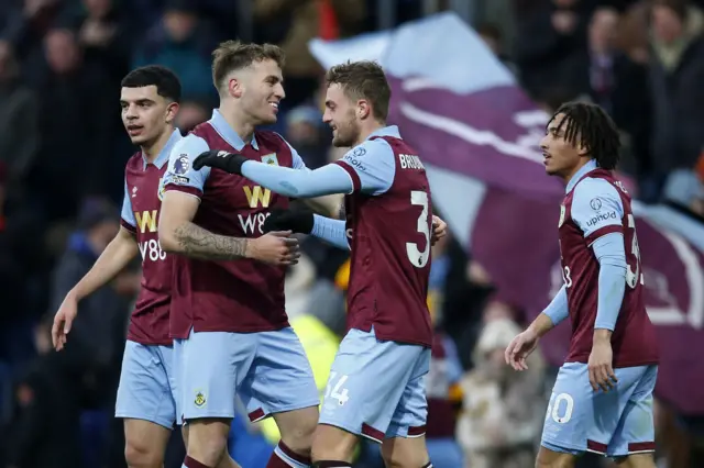 Burnley players gather to celebrate with Larsen.