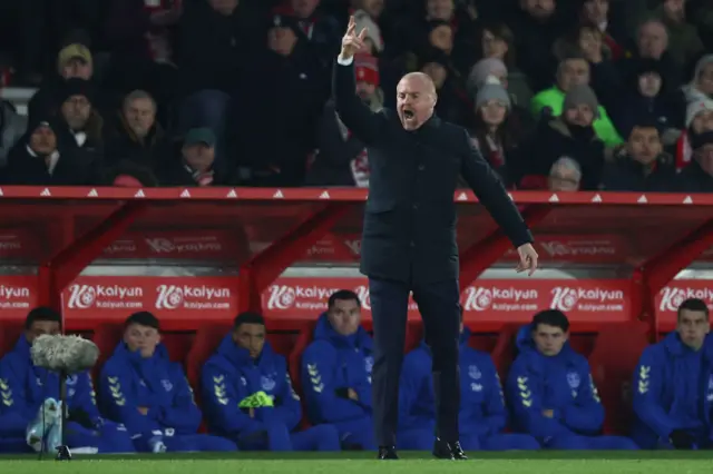 Dyche waves and screams instructions from the dugout.