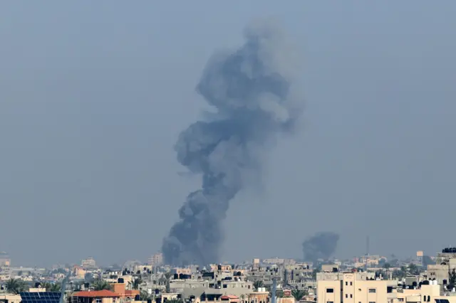 Smoke rises above buildings during Israeli strikes on Khan Younis in the southern Gaza Strip