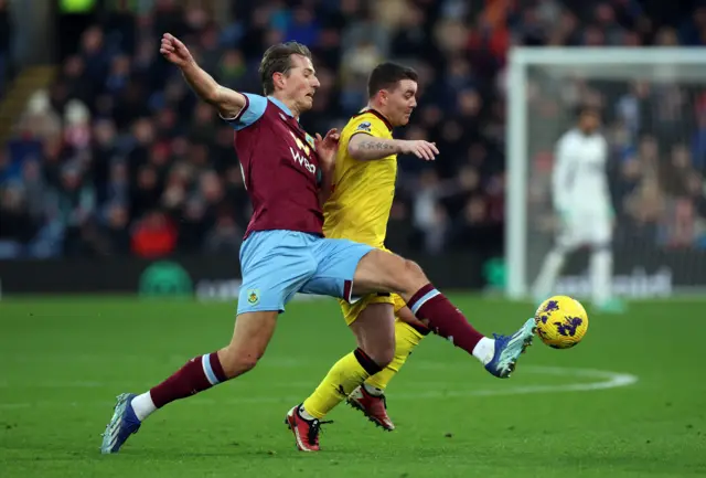 Berge tries to disposses Fleck in midfield.