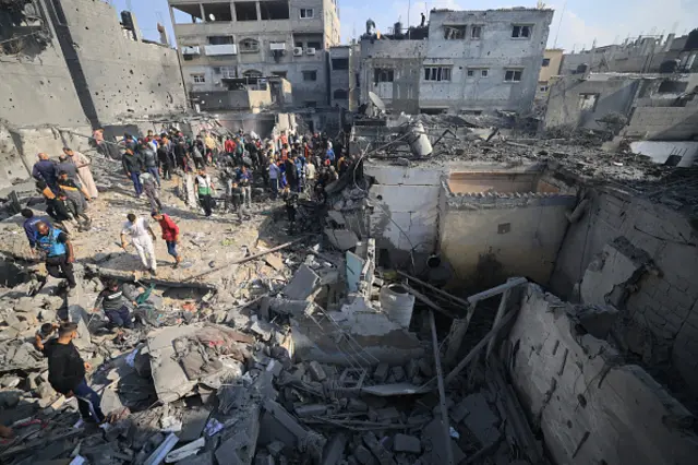 Palestinians check the damage of houses destroyed in an Israeli strike on 1 December 2023