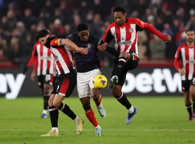 Pinnock and Norgaard crowd out a Luton midfielder.