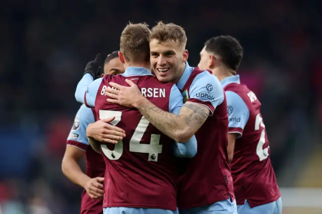 Burnley players embrace after their second goal.