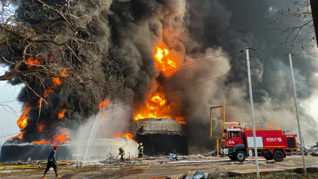 Firemen work to extinguish fire after a blast at an oil terminal in Conakry, Guinea