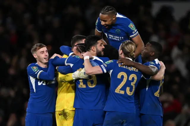 Djordje Petrovic of Chelsea celebrates their sides victory with team mates after saving a penalty taken by Matt Ritchie of Newcastle United (not pictured) following a penalty shoot out in the Carabao Cup Quarter Final match between Chelsea and Newcastle United at Stamford Bridge on December 19, 2023 in London, England