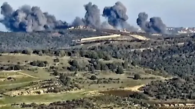 Smoke rises following what the Israeli military says is an Israeli strike on Hezbollah targets in a location given as Lebanon, amid the ongoing cross-border hostilities between Hezbollah and Israeli forces, in this screengrab taken from a handout video released on December 20, 2023