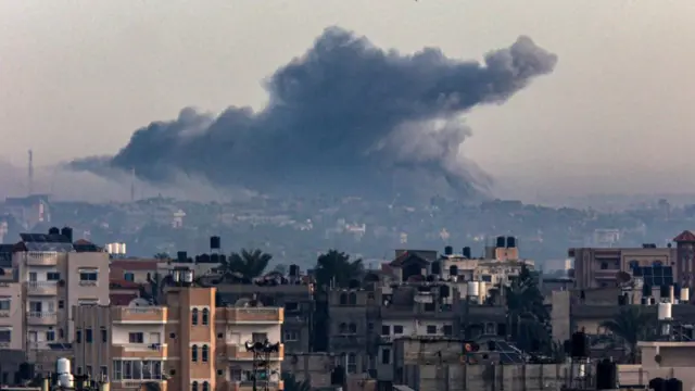 Large plume of smoke over Khan Yunis during Israeli bombardment as seen from Rafah on 20 December