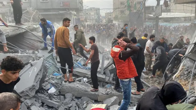 Palestinians search the site of an Israeli strike, amid the ongoing conflict between Israel and the Palestinian Islamist group Hamas, in Rafah, in the southern Gaza Strip, December 20, 2023.