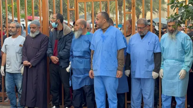 Medical staff stand next to the bodies of Palestinians killed in Israeli strikes, amid the ongoing conflict between Israel and Palestinian Islamist group Hamas, at Nasser hospital in Khan Younis, in the southern Gaza Strip, December 20, 2023.