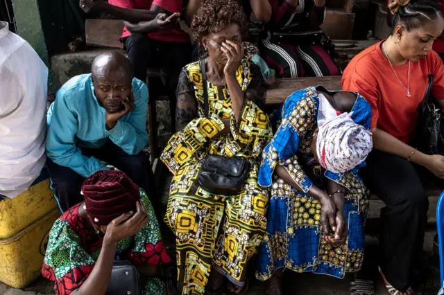 Voters wait outside a polling station for it open in Kinshasa