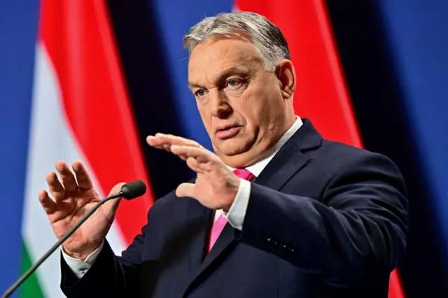 Viktor Orban - and his bright pink tie - speaking to international journalists on Thursday