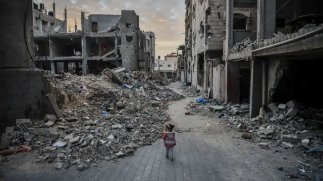 A child walks among rubbles of the destroyed buildings due to ongoing Israeli attacks on Gaza on December 21, 2023 in Rafah, Gaza. Israeli attacks on the Gaza Strip persist, conducted through air, land, and sea. Rafah has witnessed extensive destruction and severe damage to numerous settlements as a direct result of these attacks.