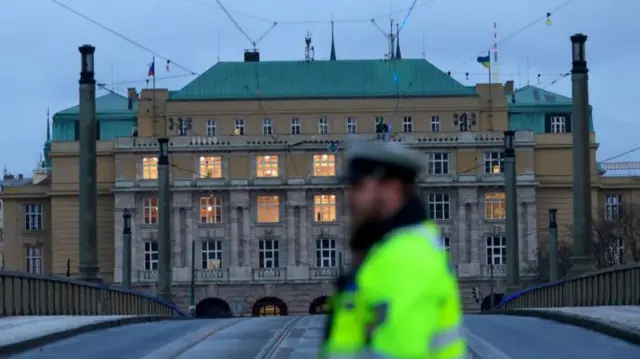 A Police officer stands at a cordon near the scene of a shooting at Charles University in central Prague