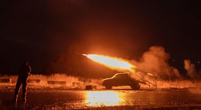 Ukrainian servicemen shoot from a self-made multiple rocket launcher on Wednesday