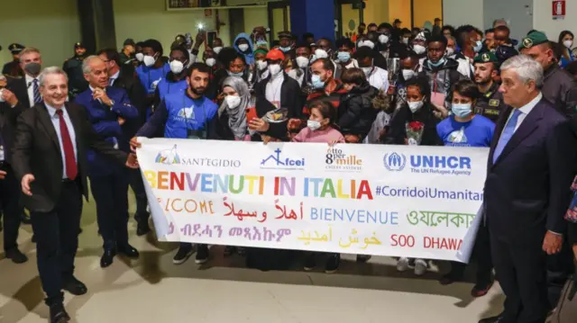 Marco Impagliazzo (L), president of St. Egidio's Community, Italy's Interior minister Matteo Piantedosi (2L) and Foreign minister Antonio Tajani (R) welcome refugees from Libya's detention camps at Rome's Fiumicino international airport, Italy, on November 30, 2022.