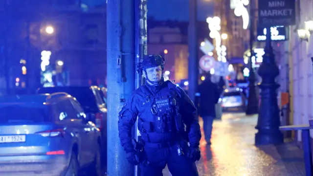 A police officer secures the area following the shooting at one of the buildings of Charles University in Prague