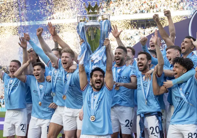 Ilkay Gudogan lifts the 2022-23 Premier League title for Manchester City