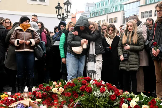 People mourn at a makeshift memorial for the victims outside the Charles University in central Prague, 22 December 2023