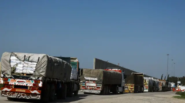 Aid trucks queue to enter Gaza at the Kerem Shalom crossing - an area which hastwo border sections: one between the Gaza Strip and Israel, and one between the Gaza Strip and Egypt.