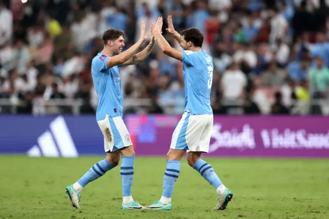 John Stones and Ruben Dias celebrate