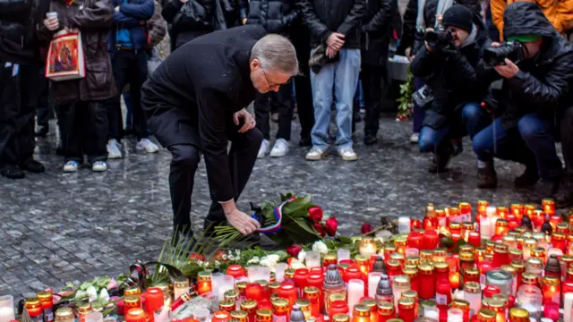 Czech Prime Minister Petr Fiala lays a bouquet of flowers