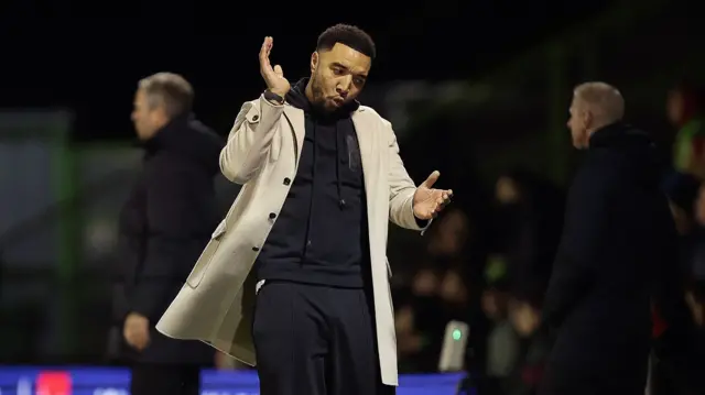 Troy Deeney reacts on the sidelines at Forest Green Rovers