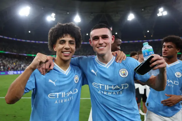 Rico Lewis and Phil Foden celebrate