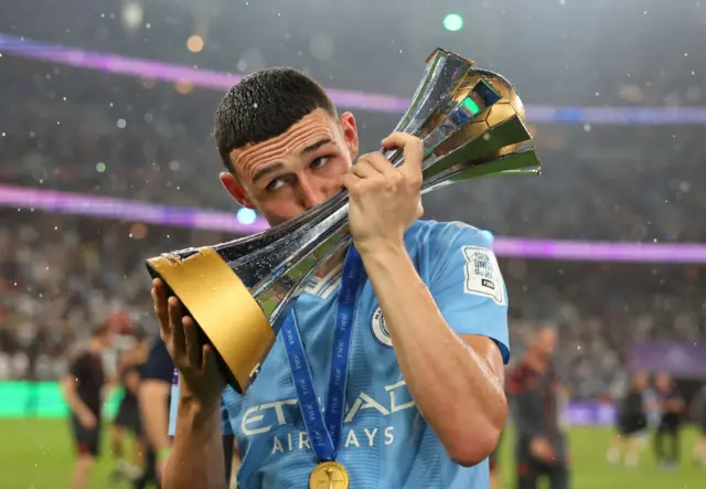 Man City's Phil Foden celebrates with the Club World Cup trophy