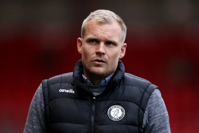 Bristol City boss Liam Manning looks pensive as he walks the touchline