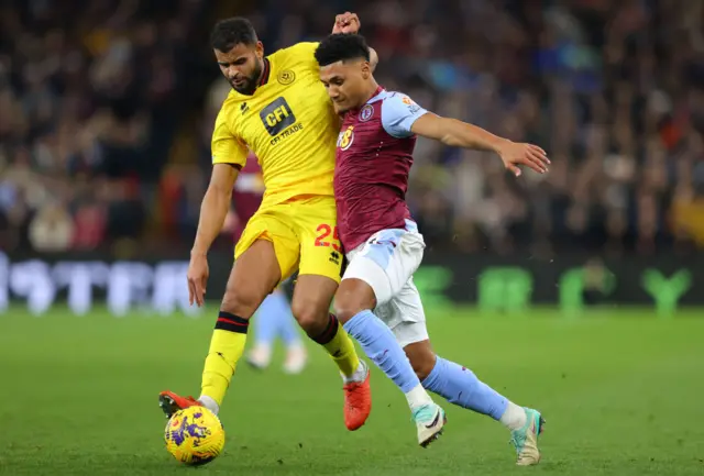 Aston Villa striker Ollie Watkins battling for the ball