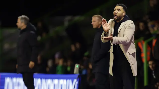 Troy Deeney applauds on the touchline