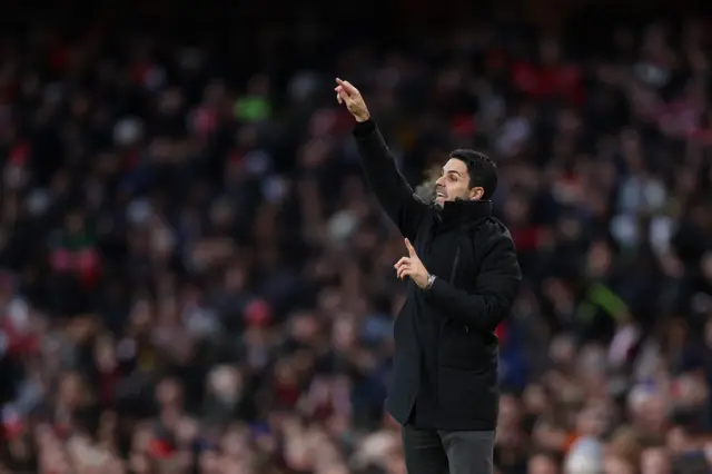 Mikel Arteta gestures to his side from the touchline.