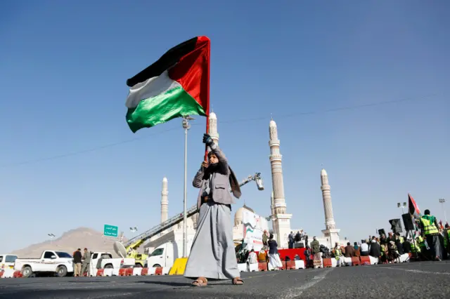 A child waves a Palestinian flag in Sanaa