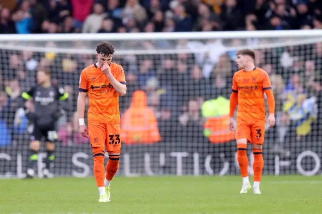 Ipswich players look dejected after Leif Davis' own goal